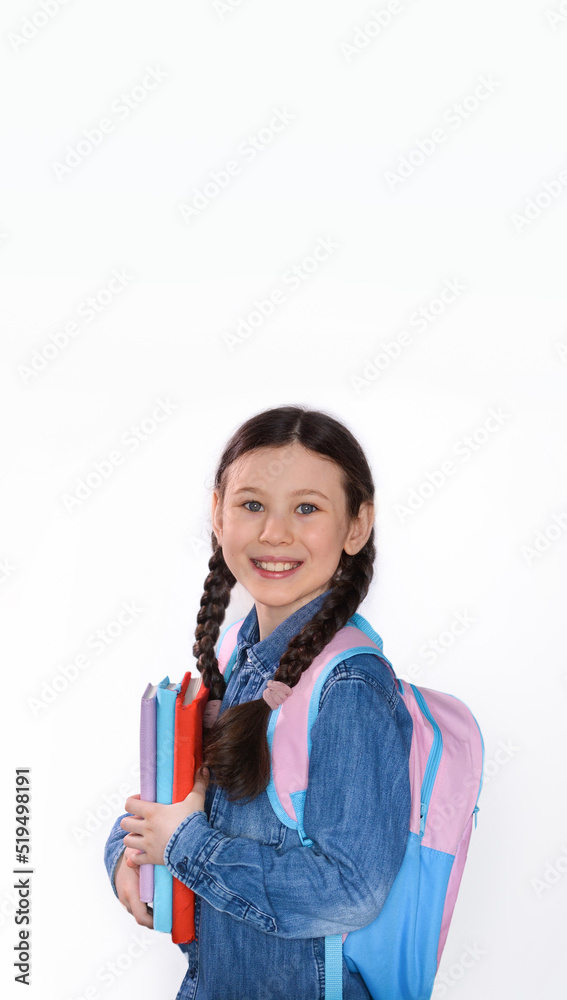 Happy teenage school child hold books white background, knowledge day. Back to school. Copy space.Vertical photo Happy teenage school child hold books white background, knowledge day. Back to school. Copy space.Vertical photo