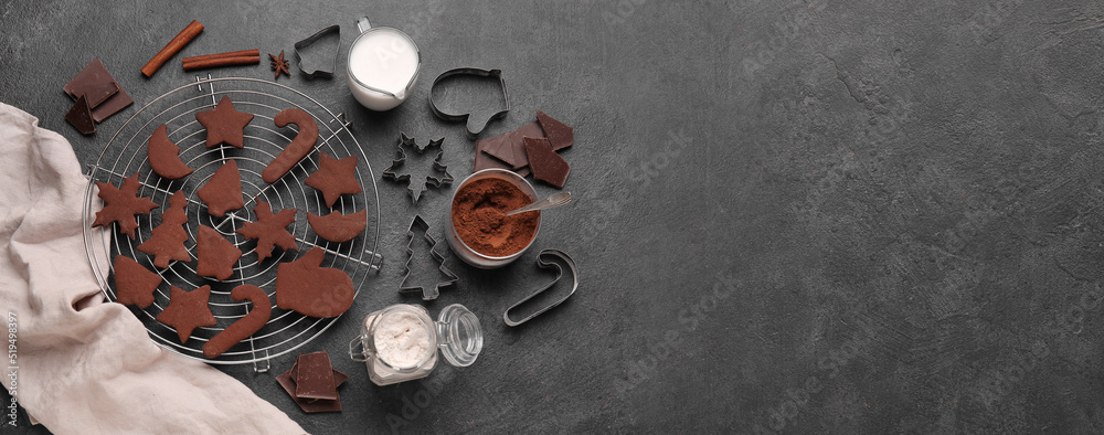 Composition with tasty chocolate Christmas cookies on black background with space for text