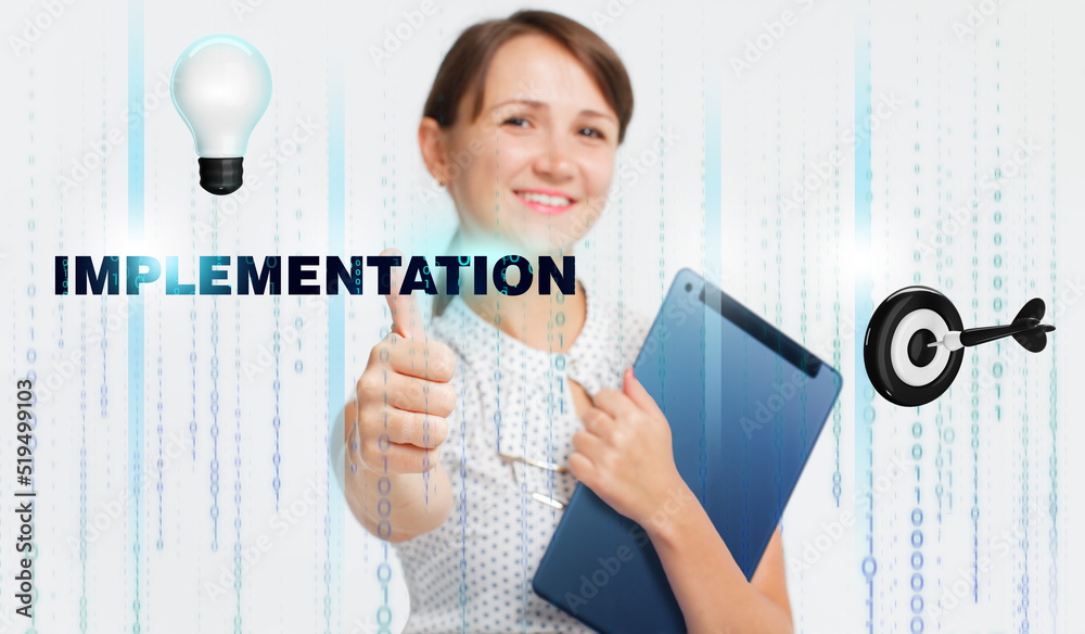 Business, Technology, Internet and network concept. Young businessman working on a virtual screen of the future and sees the inscription: Implementation