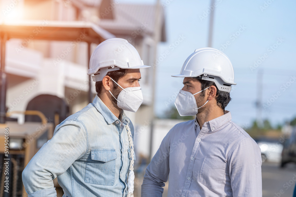 Two foreman are working at the construction of housing estates. Two foreman are working at the construction of housing estates.