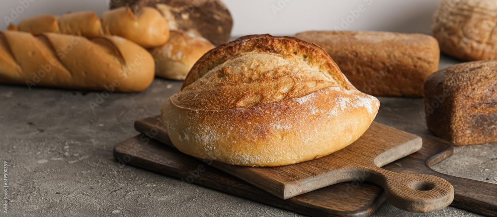 Loaf of fresh bread on grunge background Loaf of fresh bread on grunge background