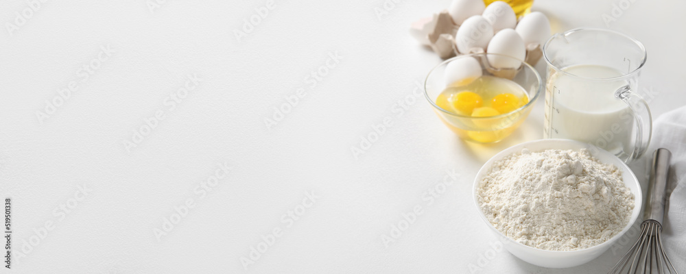 Different ingredients for baking on white background with space for text Different ingredients for baking on white background with space for text