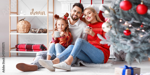 Happy family drinking hot c...