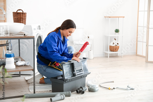 Female plumber with pipe wr...