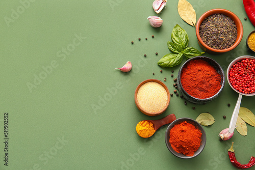 Fototapeta Naklejka Na Ścianę i Meble -  Composition with bowls of different spices on green background