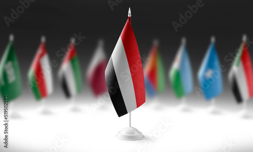 The national flag of the Yemen on the background of flags of other countries photo