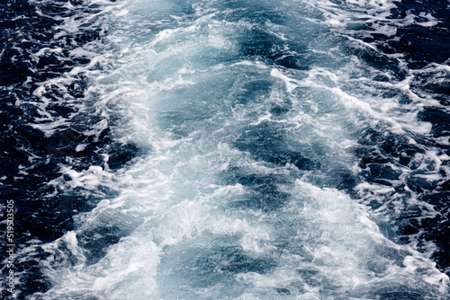 Waves and foam in the sea from boat engine