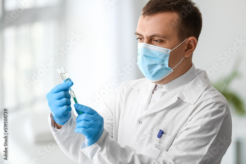 Doctor with ampule and syringe in clinic