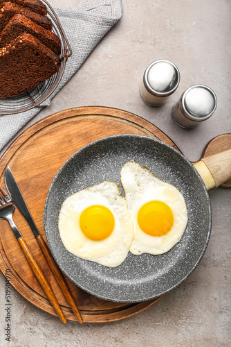 Two fried eggs in frying pa...