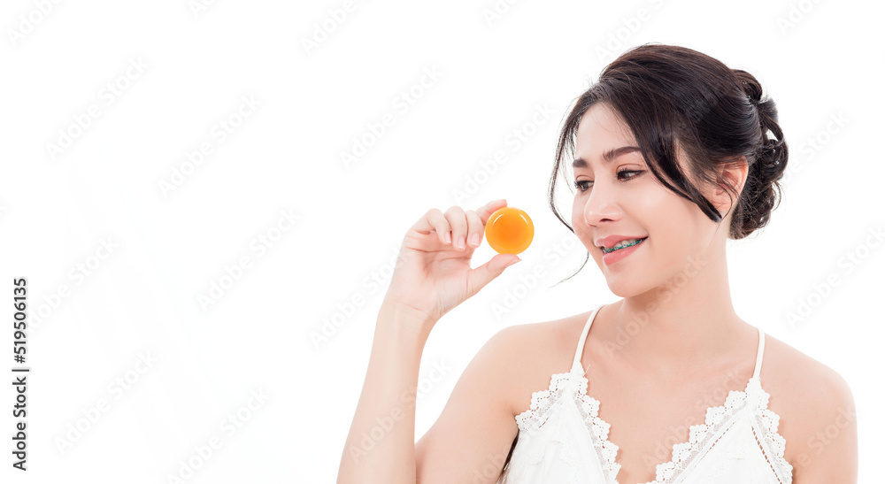 Asian young beautiful woman smiling she's holding orange handcrafted organic soap skin care near face for present product isolated on over white background, Beauty Zero waste concept Asian young beautiful woman smiling she's holding orange handcrafted organic soap skin care near face for present product isolated on over white background, Beauty Zero waste concept
