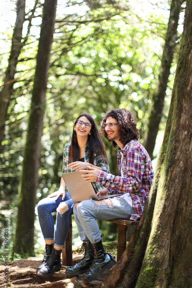 Young latin couple sitting in the forest smiling and woman with expression at Costa Rica Young latin couple sitting in the forest smiling and woman with expression at Costa Rica