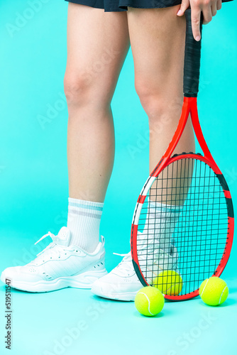 isolated Closeup on Legs of Caucasian Female Tennis Player Grasping Tennis Ball With Racket