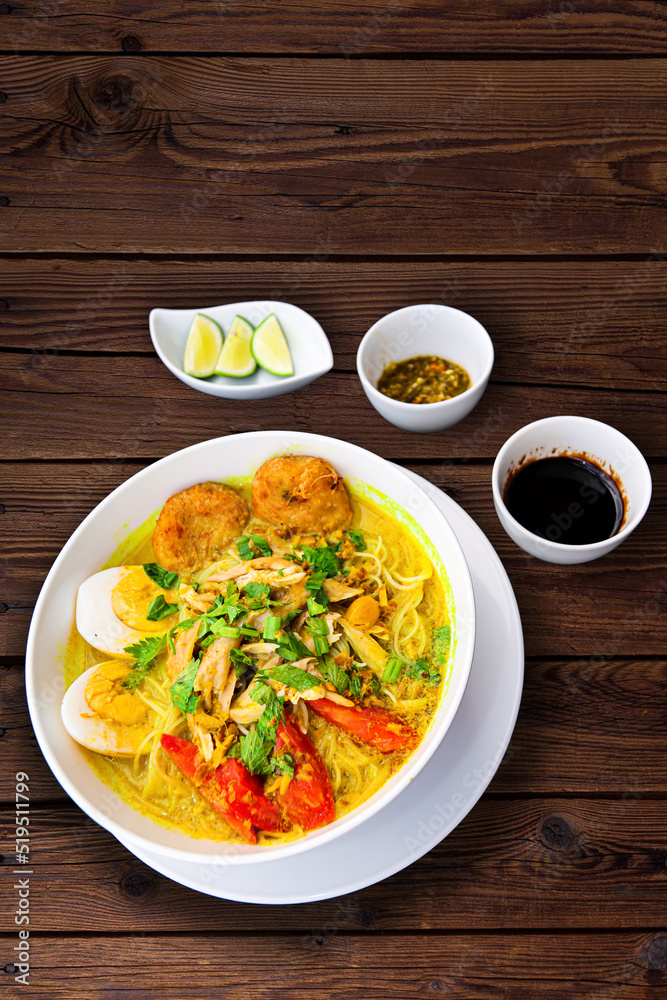 INDONESIAN CULINARY CHICKEN SOUP NOODLE WITH SLICE BOILING EGG AND FRIED MASHED POTATOS AS TOPPING INDONESIAN CULINARY CHICKEN SOUP NOODLE WITH SLICE BOILING EGG AND FRIED MASHED POTATOS AS TOPPING