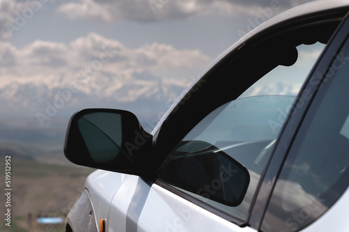 SUV concept with mountains in the clouds. Close-up of the nose of the car