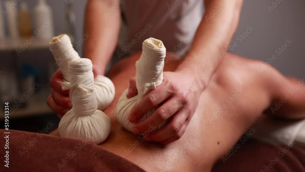 man getting a massage treatment in spa salon