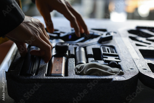 Close-up shot of videographer's hands preparing the Gimbal Stabilizers or equipment for filmmaking.