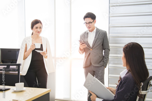 Group of business asian workers has casual meeting and relaxing time in workplace. Concept of teamwork, successful on target, casual working, relaxing workplace.