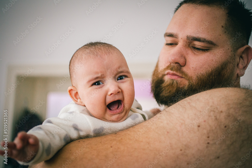 father and crying baby father and crying baby
