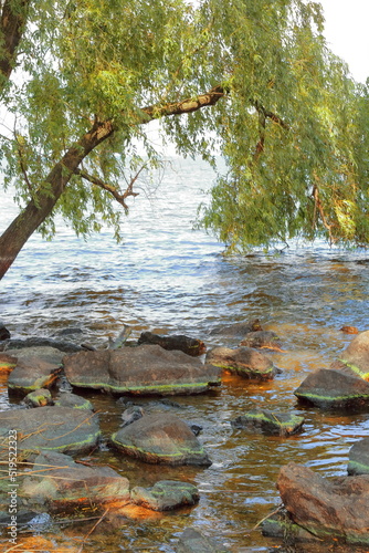 Autumn landscape with stones on the river bank