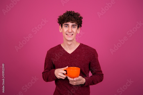 Young attractive guy is drinking coffee. 