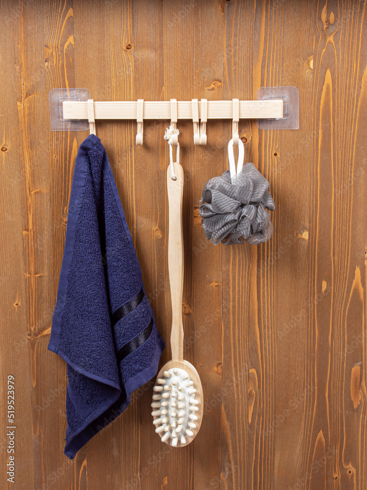 Bathroom hooks on wooden background. Plastic hanger with many