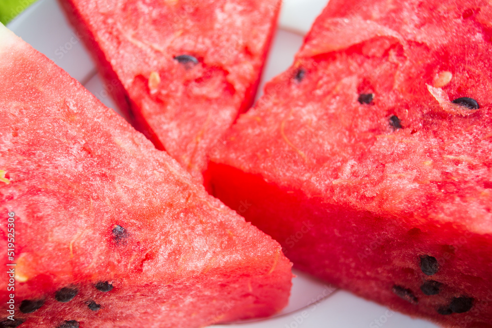 Pieces of fresh red watermelon on a plate close-up.. Harvesting healthy food concept Pieces of fresh red watermelon on a plate close-up.. Harvesting healthy food concept