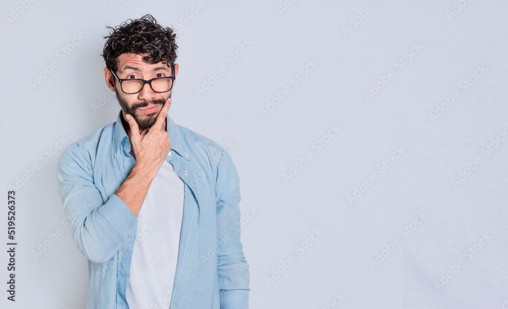 Handsome man rubbing his beard with a doubtful expression, Person rubbing his chin with a doubtful expression. handsome bearded man with doubt expression isolated Handsome man rubbing his beard with a doubtful expression, Person rubbing his chin with a doubtful expression. handsome bearded man with doubt expression isolated