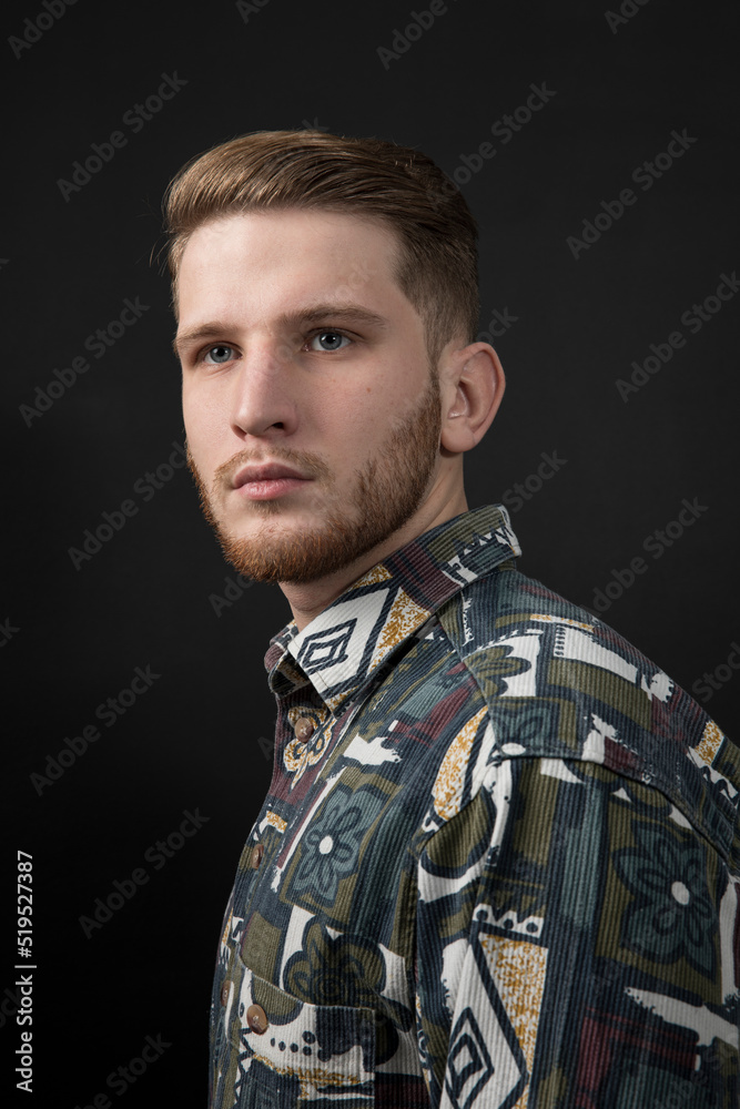 Obraz premium Handsome man in shirt - posing at studio. Attractive guy with fashion hairstyle. Adult boy with brown hair, isolated black background.