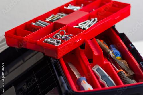 A professional toolbox full of screws of different types photo
