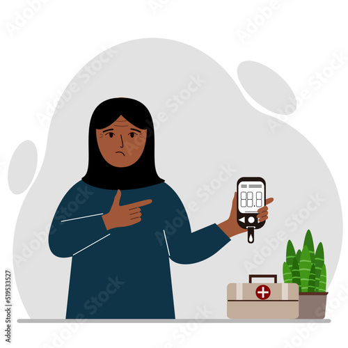Sad muslim woman holds a glucometer in his hand. The concept of blood sugar control, diabetic.