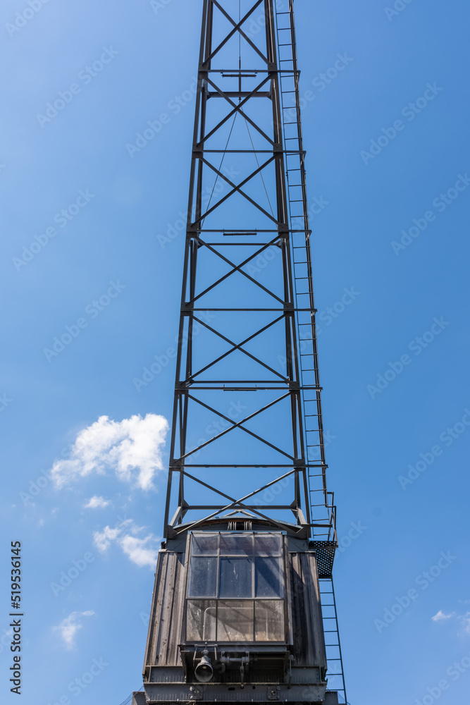 an old crane with view from below into the blue sky an old crane with view from below into the blue sky