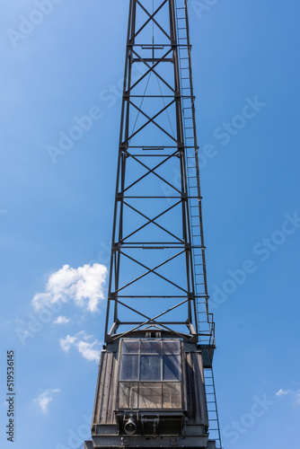 an old crane with view from below into the blue sky