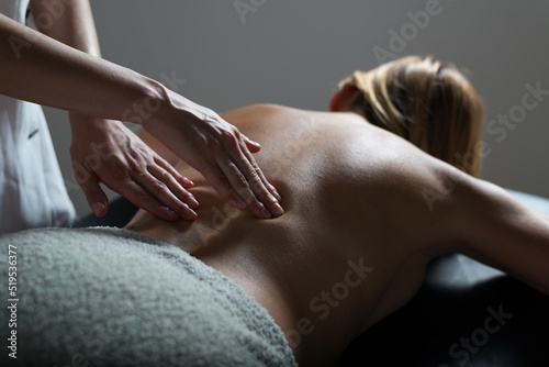 Girl getting back massage in massage salon  health spa