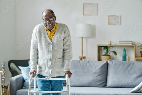 Print op canvas Portrait of African senior man with disability smiling at camera while learning