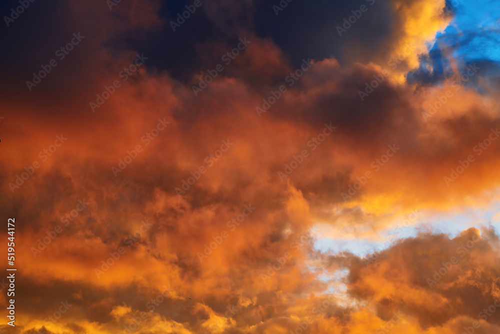 Yellow sunset sky with orange thunder clouds, thunderclouds. Nature sky background. Twilight sky, Colorful sunset sky and clouds. Fiery sunset, sky on fire.