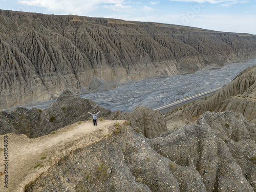 A traveler standing on the Dushanzi canyon in Xinjiang, China. photo