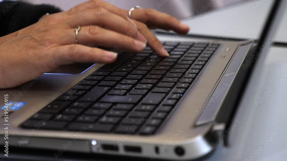 Unrecognizable woman using laptop at home Unrecognizable woman using laptop at home