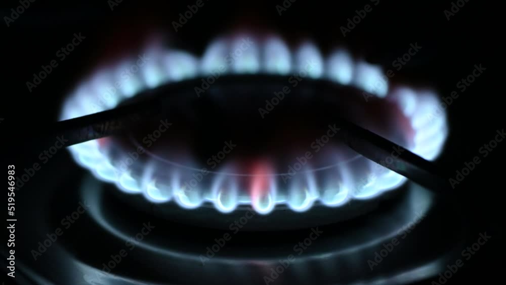 Kitchen burner turning on.Stove top burner igniting into a blue cooking flame Kitchen burner turning on.Stove top burner igniting into a blue cooking flame