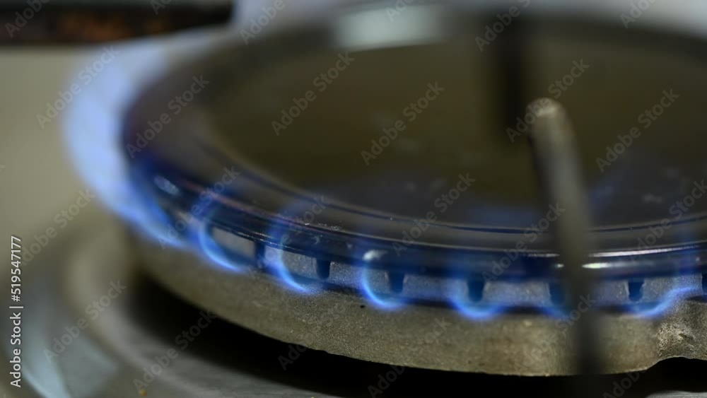 Close-up of stove gas-burner with burning blue flame. Close-up of stove gas-burner with burning blue flame.