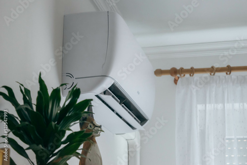 Split air conditioner on a white wall closeup photo