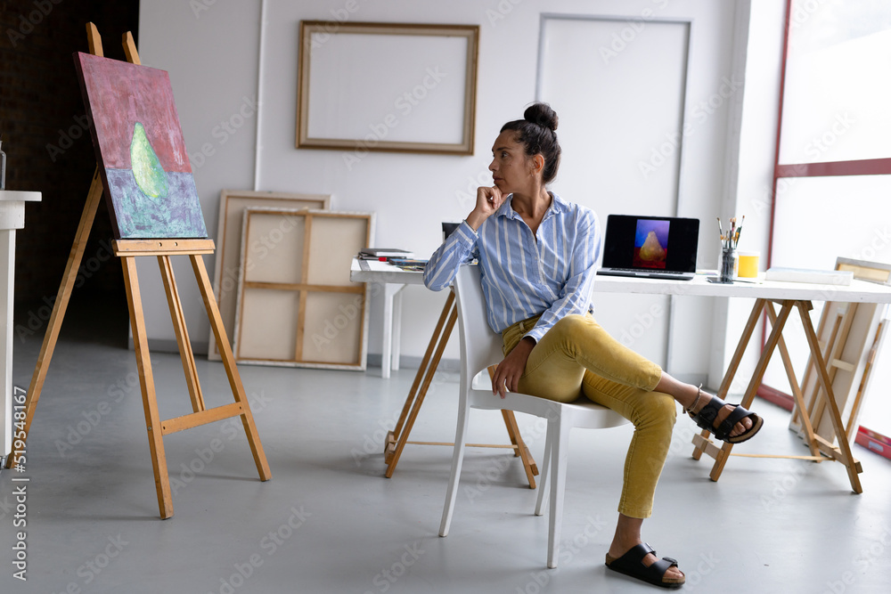 custom made wallpaper toronto digitalImage of thoughtful biracial female artist sitting on chair in studio