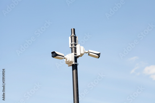 Surveillance Security Camera against the blue sky.