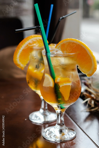 cold alcohol cocktail with orange in glasses.