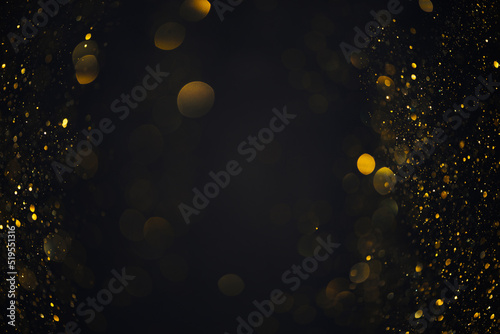 Golden swirly bokeh shiny glitter lights overlay on dark background