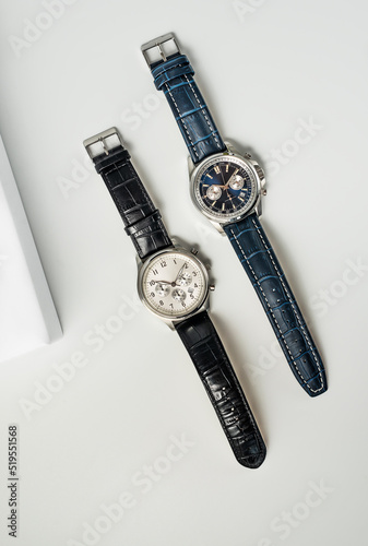 Studio shot of a two fancy luxury unbranded Men watches on white background. Stainless steel man's wrist watches with leather straps.