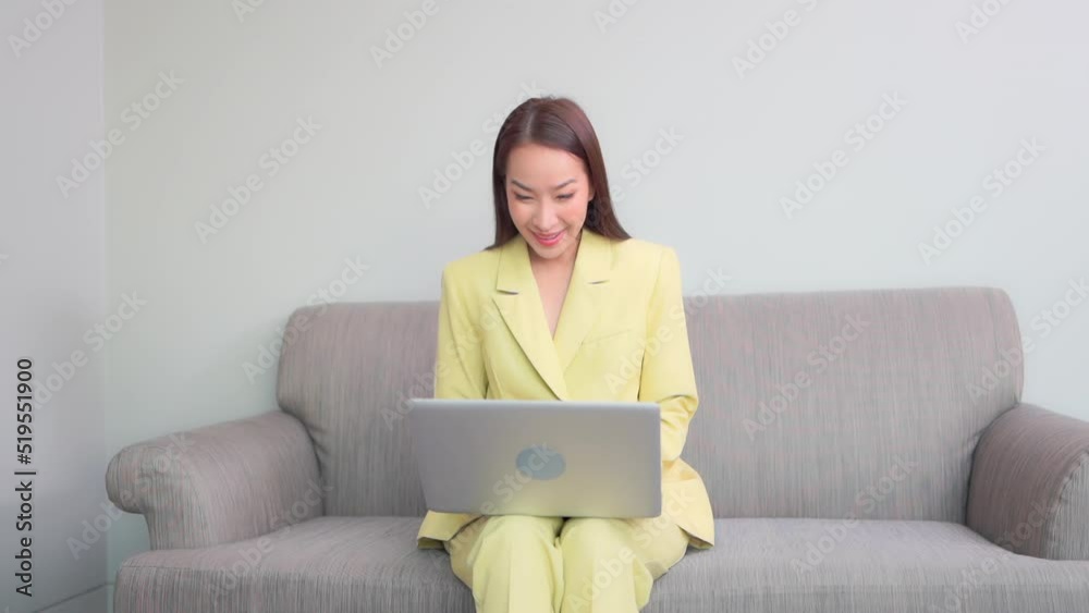 Young Asian Business Woman Typing on Laptop and Celebrate Win of Business Deal With Hand Fist Gesture Young Asian Business Woman Typing on Laptop and Celebrate Win of Business Deal With Hand Fist Gesture