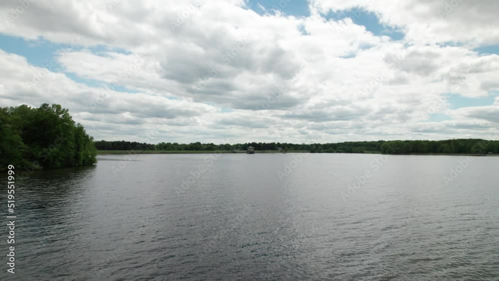 Aerial view of a beautiful old lighthouse in the lake with clouds covered in the sky Aerial view of a beautiful old lighthouse in the lake with clouds covered in the sky