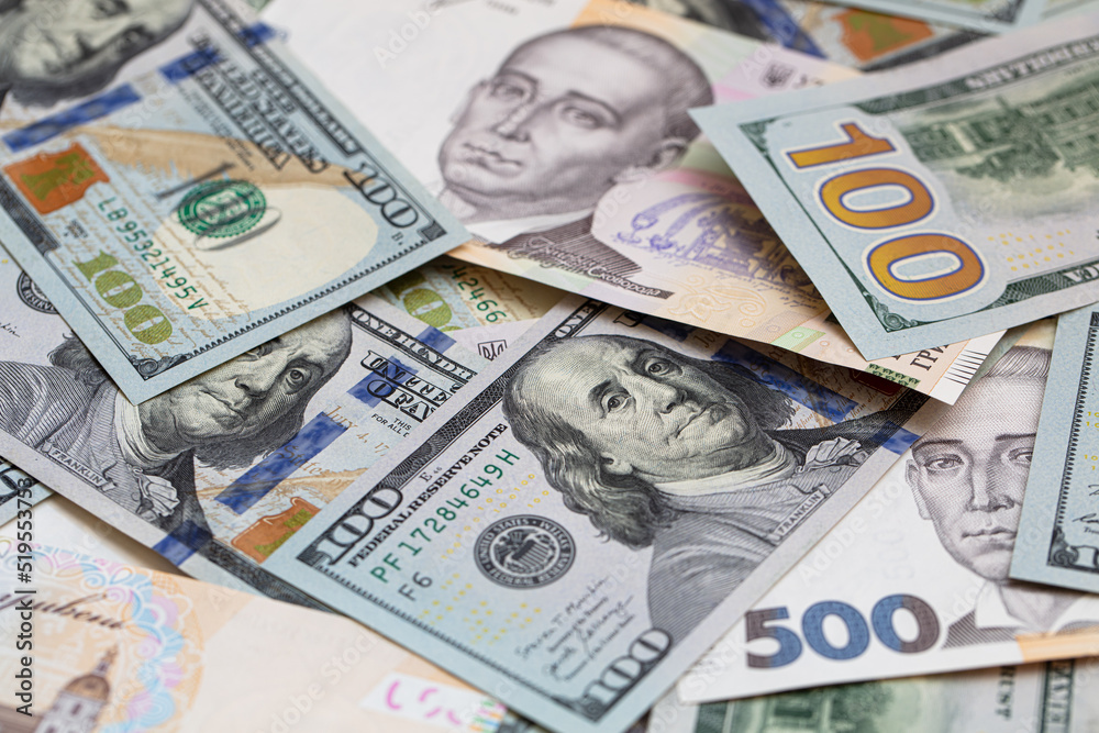 Obraz premium 100 dollar and 500 hryvnyas banknotes background