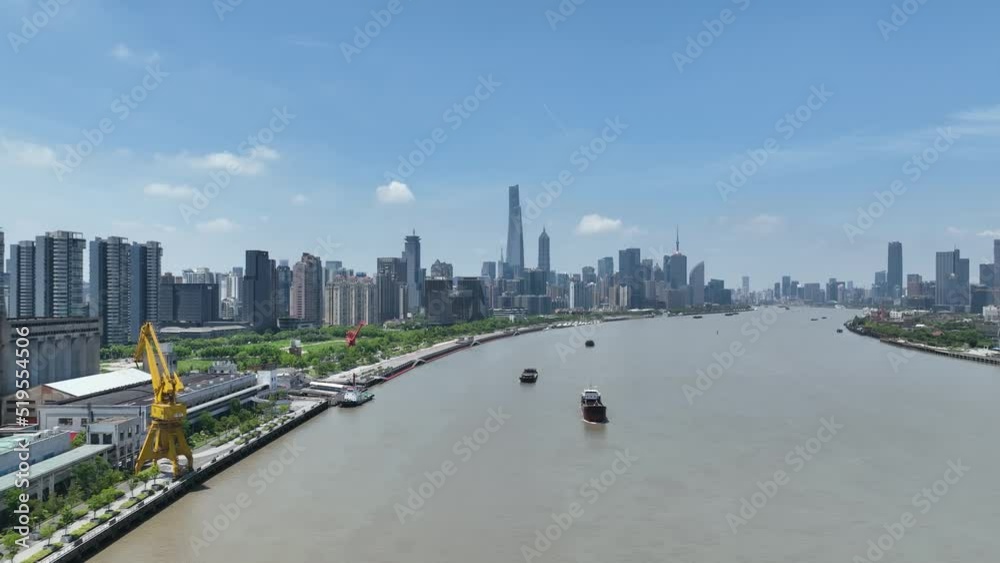 Timelapse of City skyline, river and boat moving . Drone aerial view. Flying over the Huangpu River and the Shanghai Lujiazui downtown epic mood. Business, economy and travel concept b-roll footage. Timelapse of City skyline, river and boat moving . Drone aerial view. Flying over the Huangpu River and the Shanghai Lujiazui downtown epic mood. Business, economy and travel concept b-roll footage.