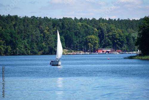 Sailboat swimming on a lake - front view